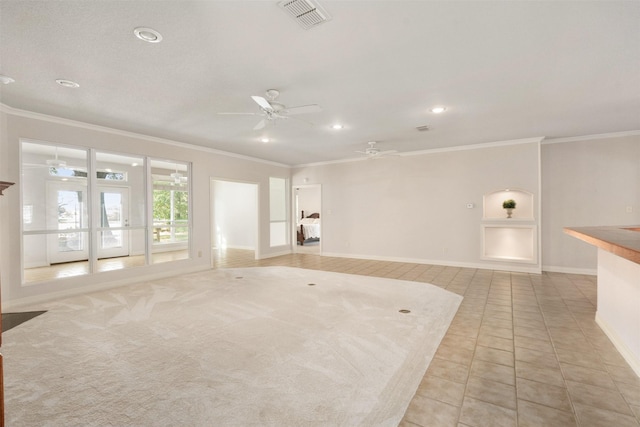 carpeted spare room with ceiling fan and crown molding