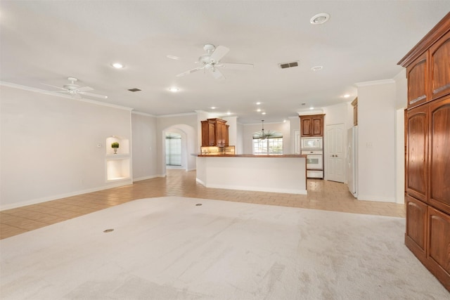 unfurnished living room featuring light tile patterned floors, ceiling fan, and crown molding