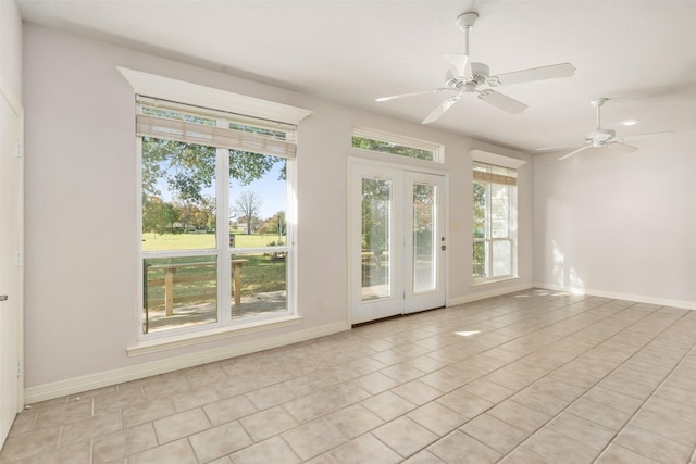 spare room featuring ceiling fan and light tile patterned flooring