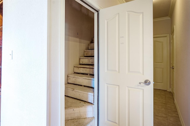 stairs featuring tile patterned floors and ornamental molding