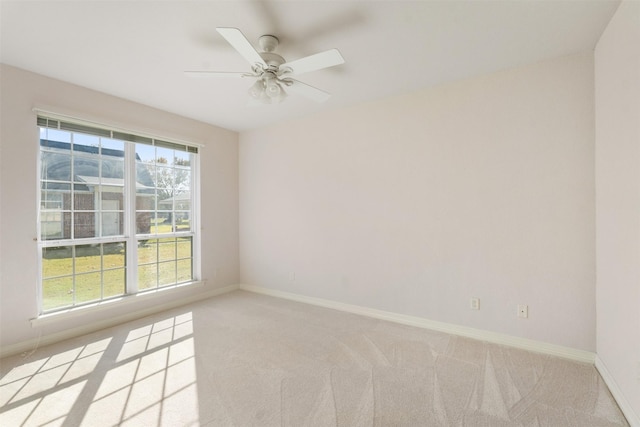 unfurnished room with ceiling fan and light colored carpet