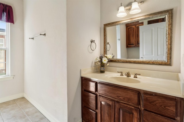 bathroom featuring tile patterned flooring, vanity, and a healthy amount of sunlight