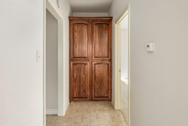 hallway with light tile patterned floors