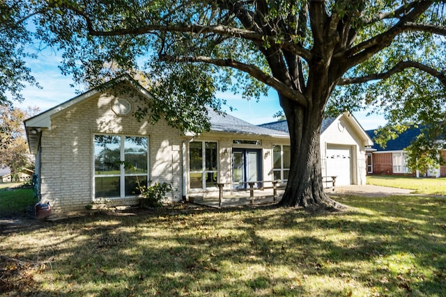 ranch-style house with a garage and a front lawn