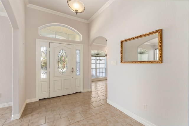 tiled entrance foyer with a towering ceiling and crown molding