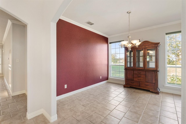 unfurnished dining area with crown molding, plenty of natural light, and an inviting chandelier