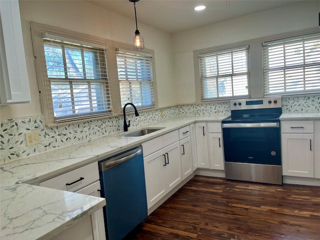 kitchen featuring sink, pendant lighting, plenty of natural light, and appliances with stainless steel finishes