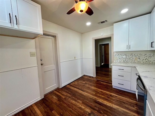 kitchen with dishwasher, dark hardwood / wood-style floors, ceiling fan, light stone counters, and white cabinetry