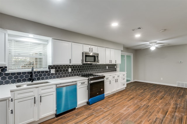 kitchen with stainless steel appliances, white cabinetry, dark hardwood / wood-style floors, and sink