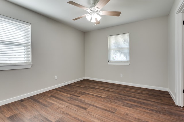 unfurnished room featuring dark hardwood / wood-style flooring, ceiling fan, and plenty of natural light