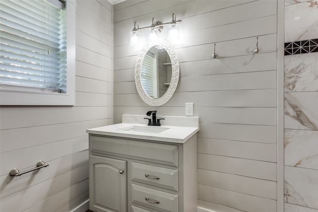 bathroom with vanity and wooden walls