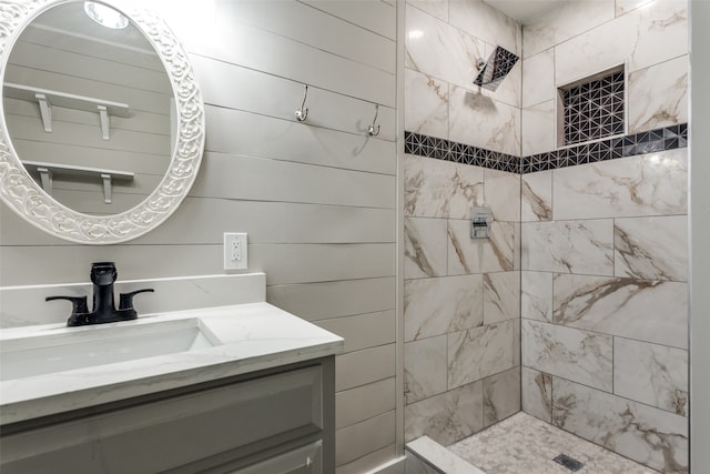 bathroom featuring vanity and tiled shower