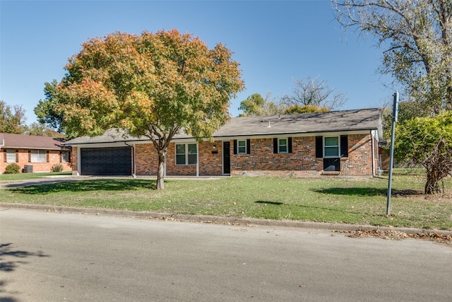 single story home featuring a garage and a front lawn