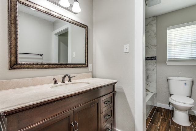 full bathroom with vanity, toilet, and tiled shower / bath