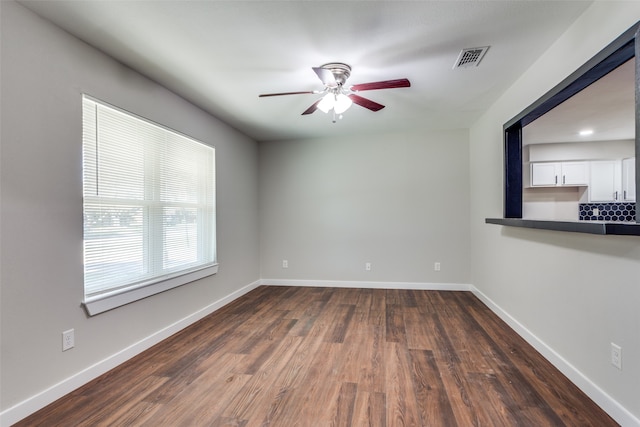 spare room with ceiling fan and dark hardwood / wood-style flooring