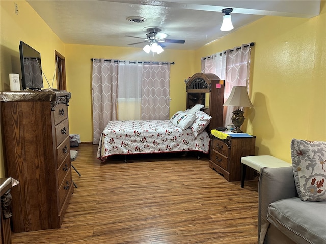 bedroom with ceiling fan and hardwood / wood-style floors