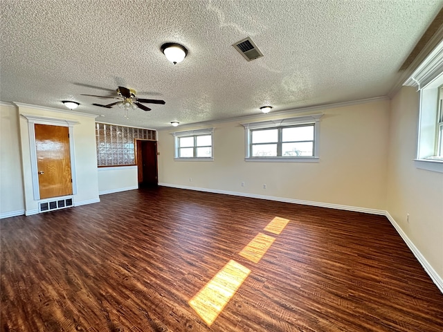 unfurnished room with dark wood-type flooring, ceiling fan, crown molding, and a textured ceiling