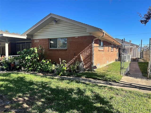 view of side of home with a lawn