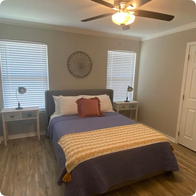 bedroom featuring hardwood / wood-style floors, crown molding, and ceiling fan