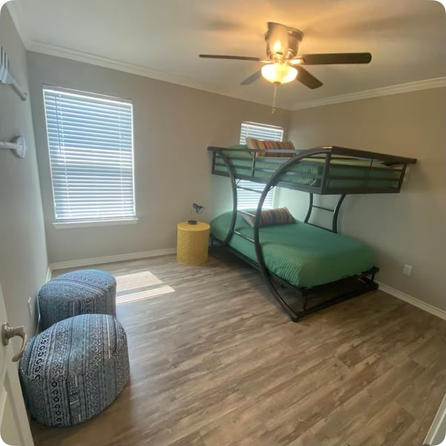 bedroom featuring multiple windows, wood-type flooring, and ornamental molding