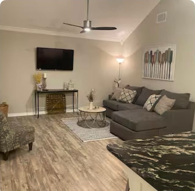 living room featuring hardwood / wood-style flooring, ornamental molding, and ceiling fan