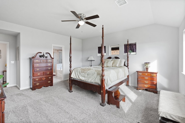 bedroom featuring ceiling fan, light colored carpet, connected bathroom, and vaulted ceiling