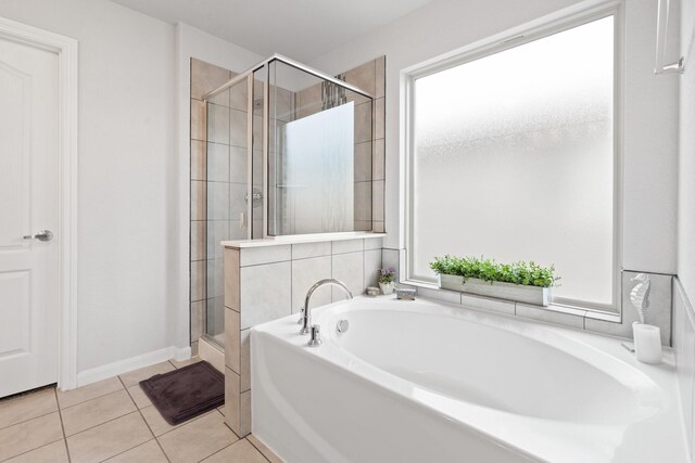 bathroom featuring tile patterned floors and independent shower and bath