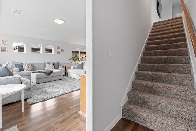 stairway with hardwood / wood-style flooring