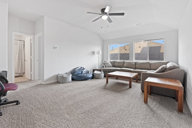 carpeted living room with ceiling fan and lofted ceiling