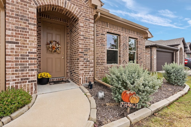 doorway to property with a garage