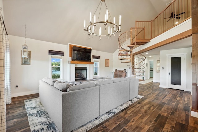 living room with dark hardwood / wood-style flooring, high vaulted ceiling, and a notable chandelier