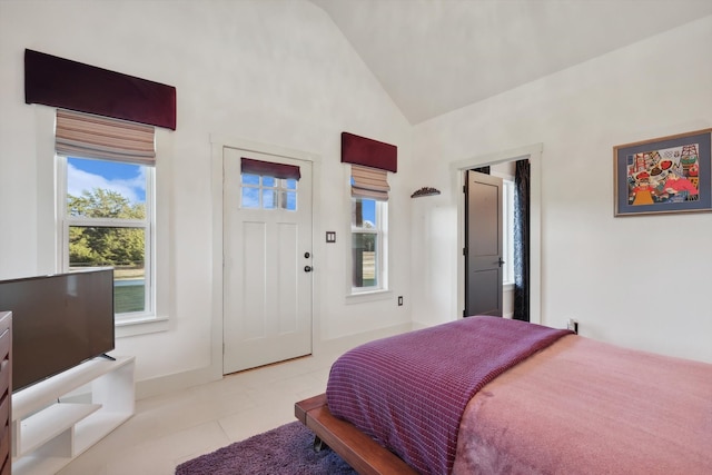 bedroom featuring vaulted ceiling and light tile patterned flooring