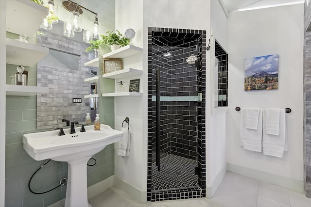 bathroom with an enclosed shower, tile patterned flooring, tasteful backsplash, and tile walls