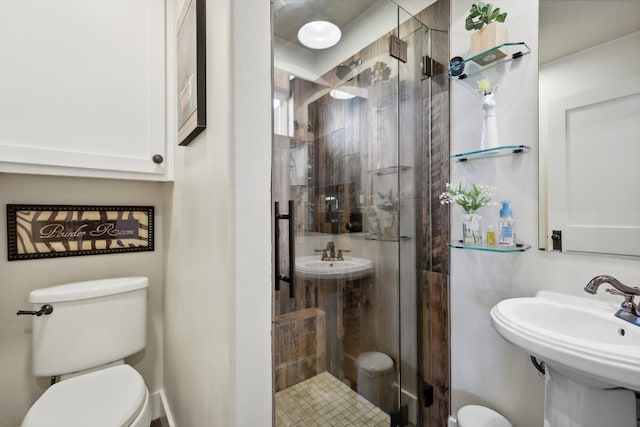 bathroom featuring walk in shower, toilet, and sink