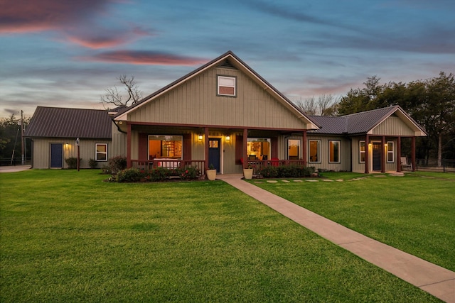 view of front of home with a yard and covered porch