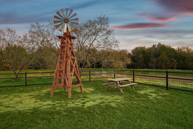 playground at dusk featuring a lawn