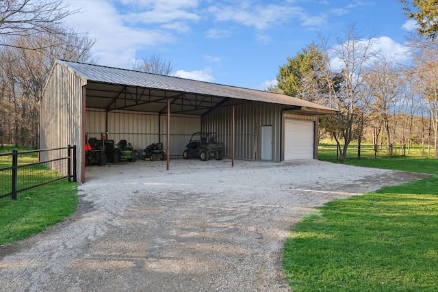 view of outdoor structure featuring a garage and a lawn