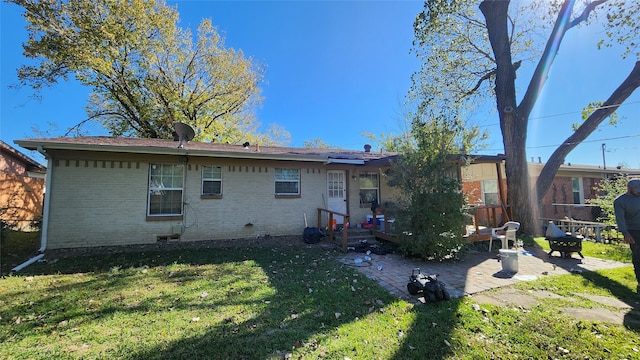 rear view of house featuring solar panels, a yard, and a patio