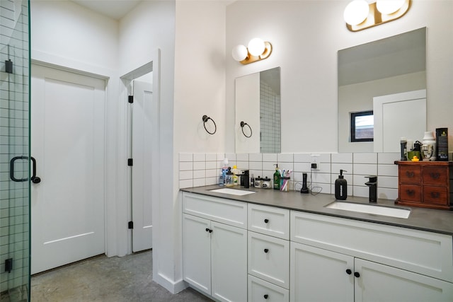 bathroom with decorative backsplash, vanity, a shower with door, and concrete floors