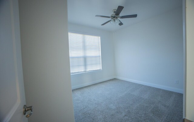 unfurnished room with ceiling fan and carpet flooring