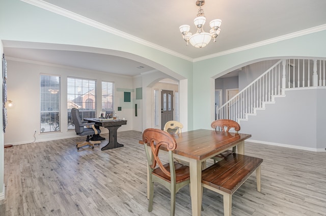 dining room with ornamental molding, a chandelier, and light wood-type flooring