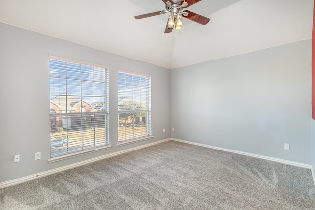 carpeted spare room with vaulted ceiling and ceiling fan