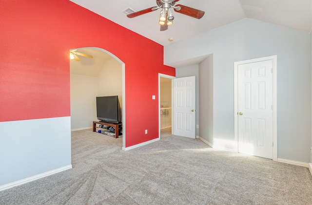 interior space featuring light carpet, vaulted ceiling, and ceiling fan