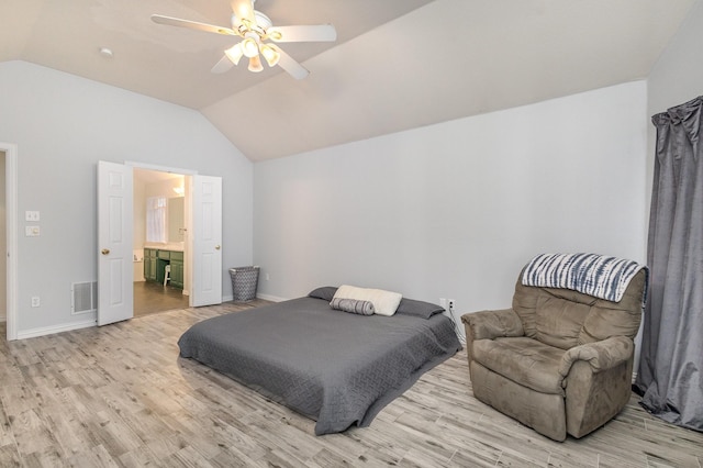 bedroom featuring ceiling fan, ensuite bathroom, light hardwood / wood-style floors, and vaulted ceiling