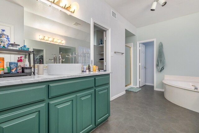 bathroom with tile patterned flooring, vanity, and independent shower and bath