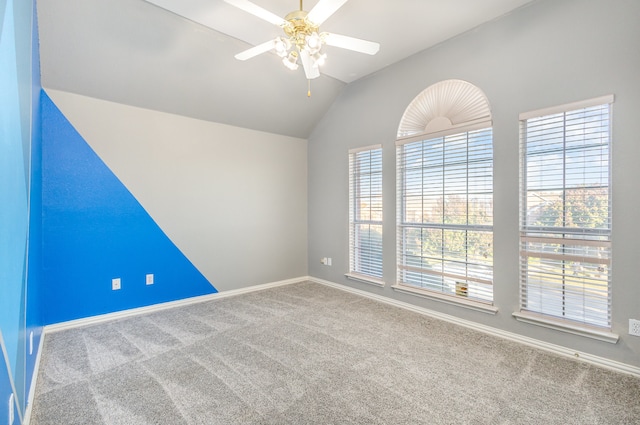 unfurnished room with carpet floors, vaulted ceiling, and ceiling fan