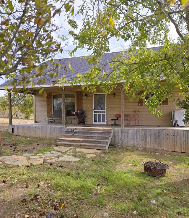 rear view of house featuring a fire pit