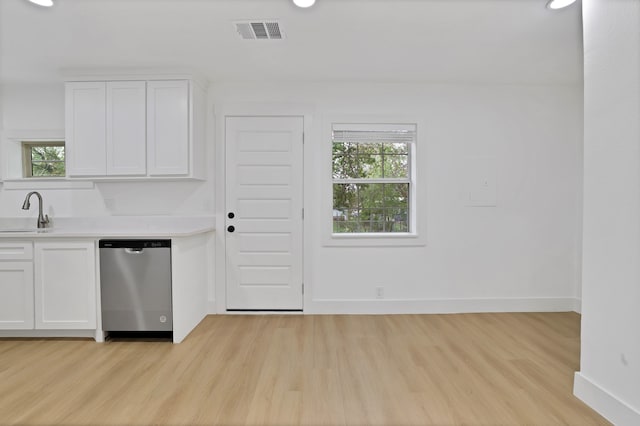 kitchen with dishwasher, light hardwood / wood-style floors, white cabinetry, and sink