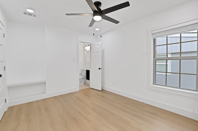 unfurnished bedroom featuring ceiling fan, light hardwood / wood-style floors, and ensuite bath