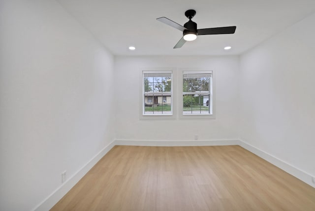 unfurnished room with ceiling fan and light hardwood / wood-style floors